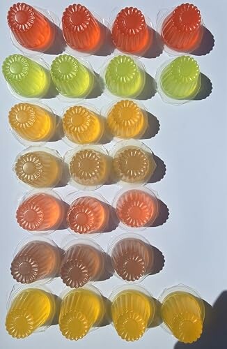 Assorted colorful jelly cups arranged in rows.