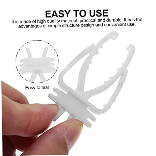 Hand holding a white plastic tool with prongs, described as easy to tear.