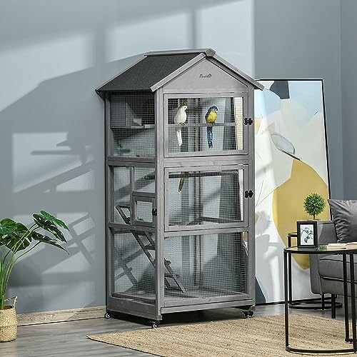 Indoor bird cage with two parrots in a modern room.