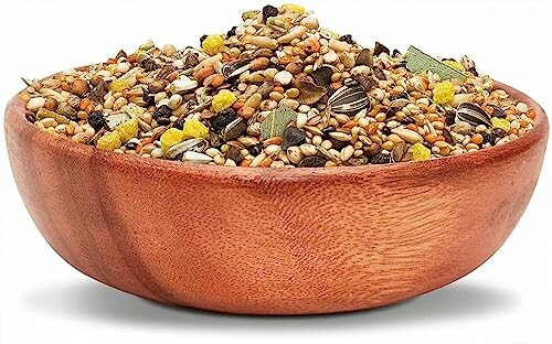 Wooden bowl filled with a mixture of bird seeds.